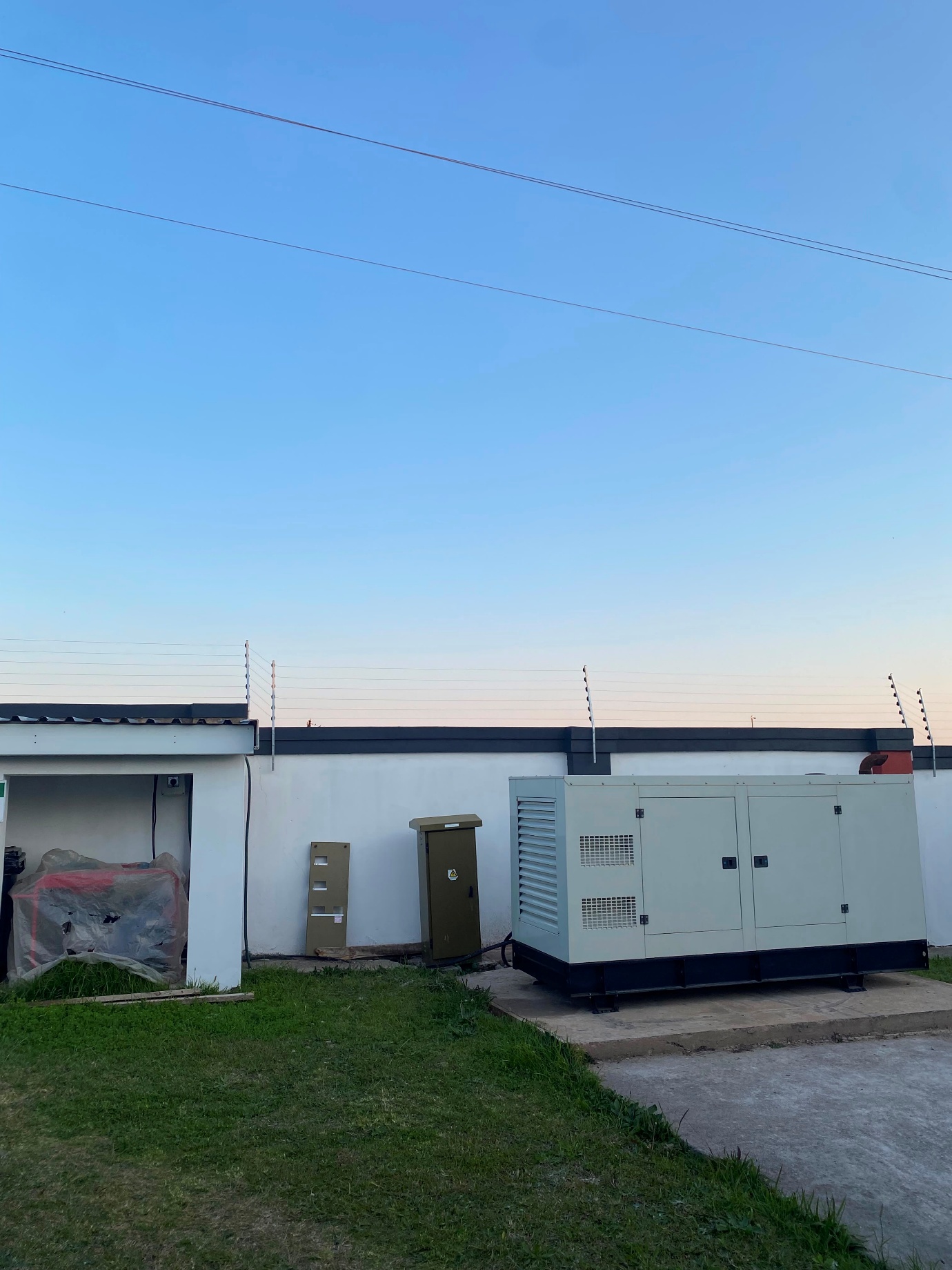 Backup power generator behind the residence perimeter wall