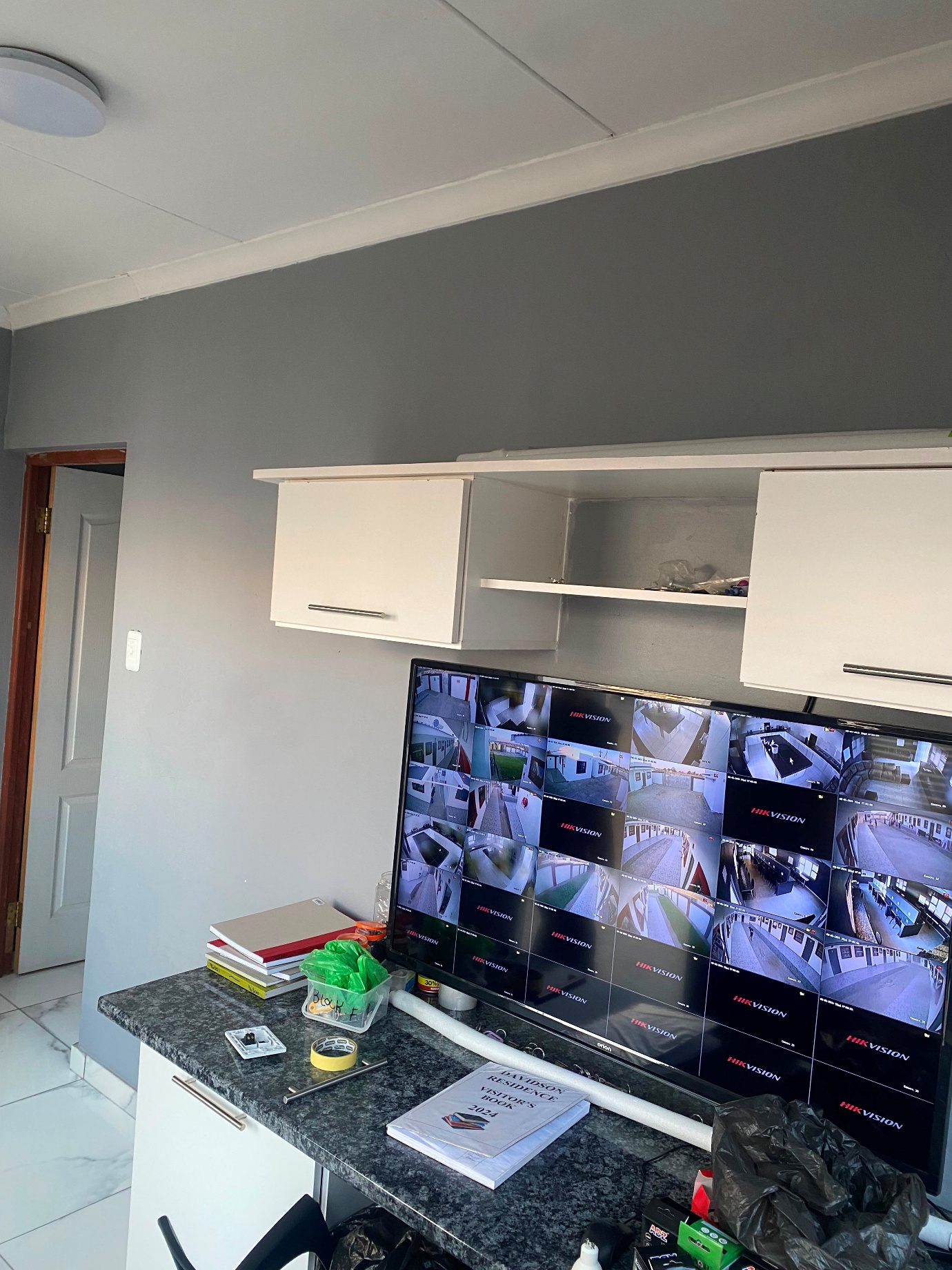 CCTV control room monitoring the residence with multiple camera feeds